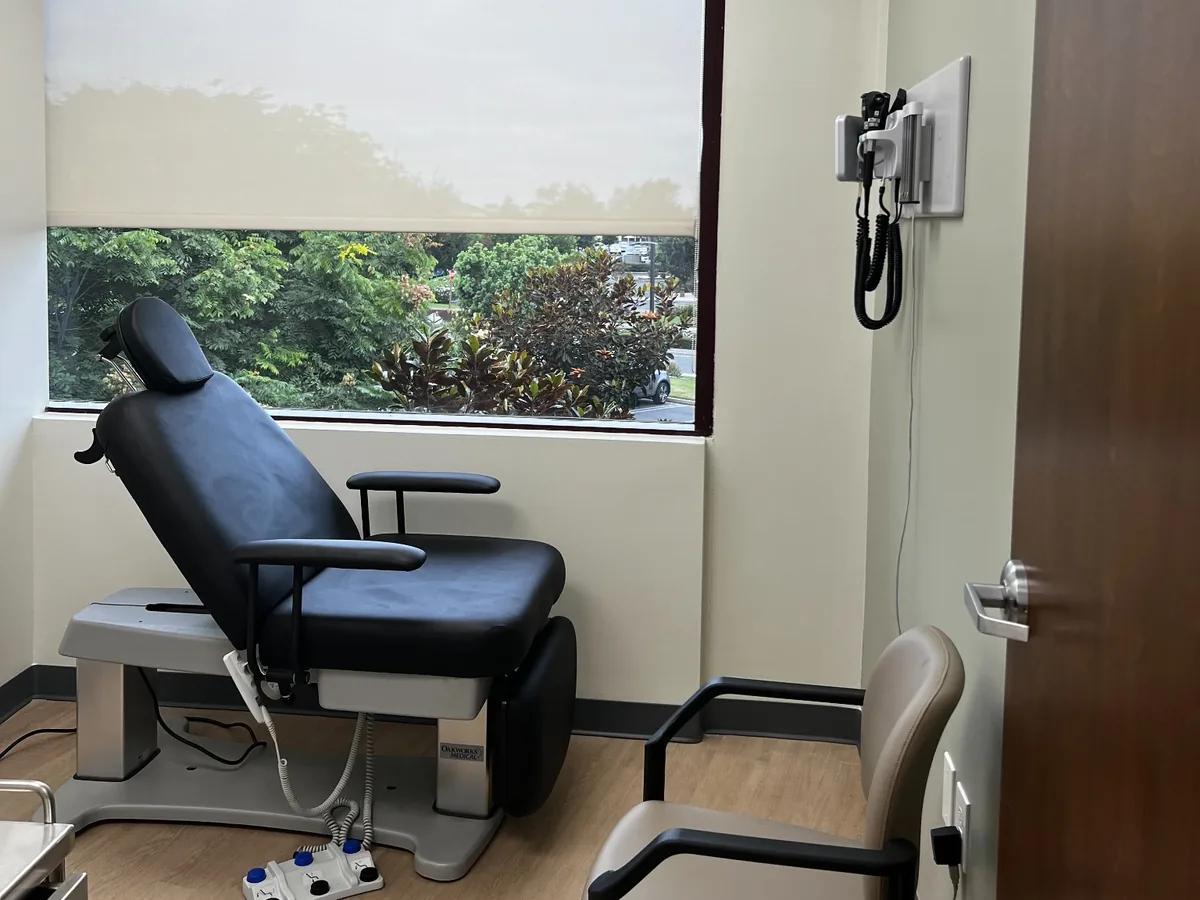 Procedure chair and wall‑mounted vitals unit in exam room